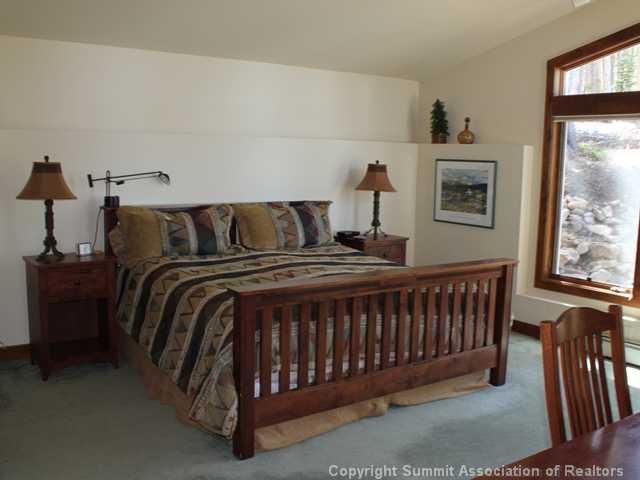 576 Moonstone Road Breckenridge, CO 80424 - Photo 16 of 22 a bed sitting in a bedroom next to a window