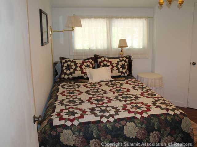 576 Moonstone Road Breckenridge, CO 80424 - Photo 18 of 22 a large bed sitting in a bedroom next to a window