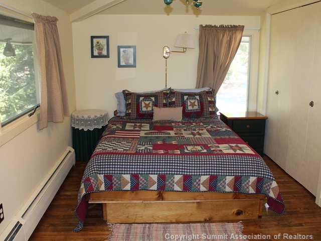 576 Moonstone Road Breckenridge, CO 80424 - Photo 19 of 22 a bed sitting in a bedroom next to a window