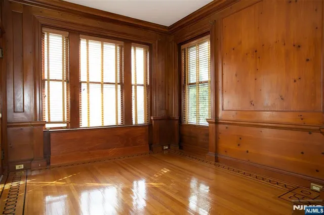 a living room with furniture and large windows