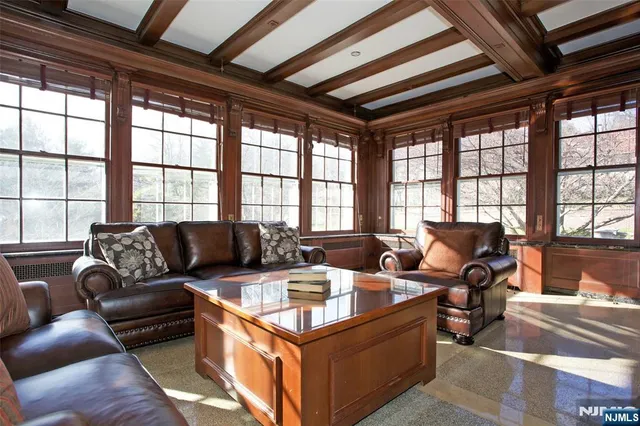 a living room with a table chairs and a fireplace
