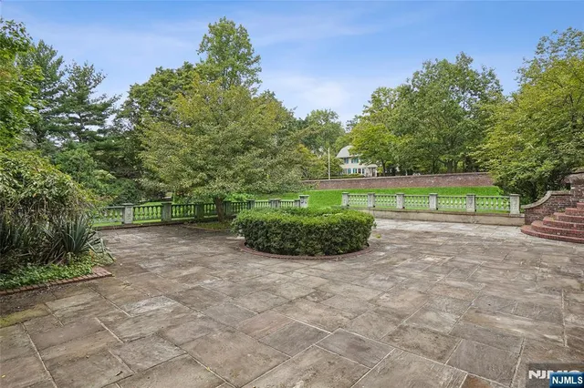 a view of a house with a big yard and large trees