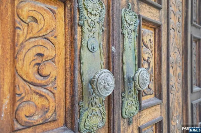 a view of a hallway with wooden floor and a rug