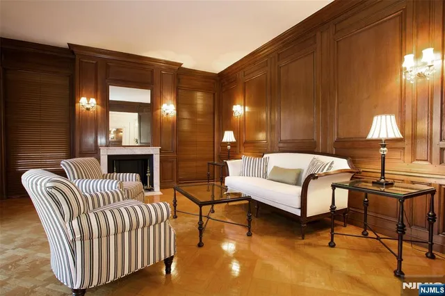 a view of a hallway with wooden floor and a dining room