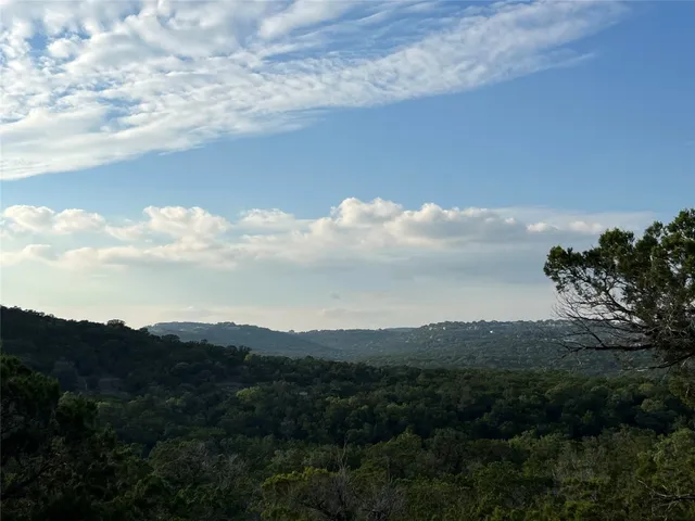 a view of a house with a mountain in the background