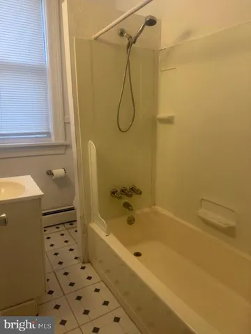 a bathroom with a bath tub with a shower