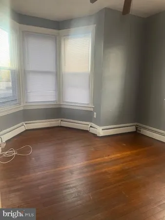 a view of a room with wooden floor and window