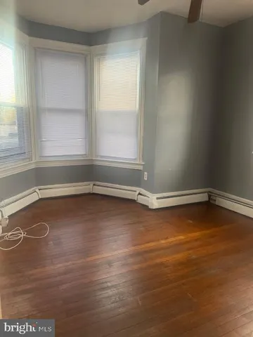 a view of a room with wooden floor and window