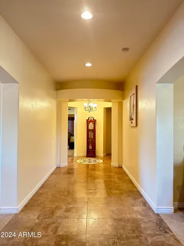 a view of a hallway with wooden shelves