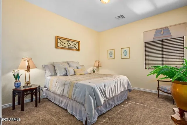 a bedroom with bed and a window