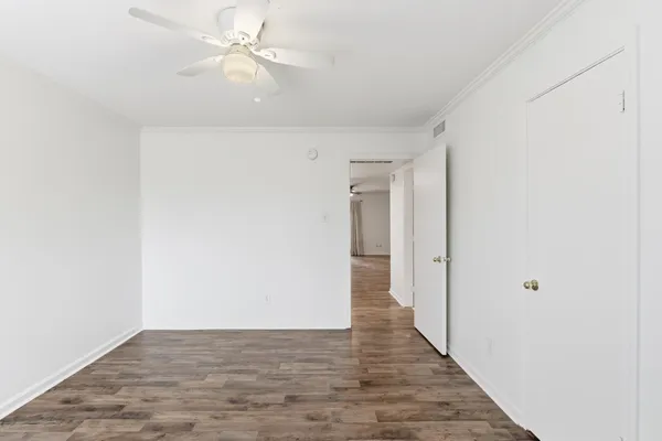 a view of a hallway with wooden floor