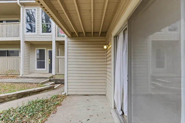 a view of a porch with a table and chairs