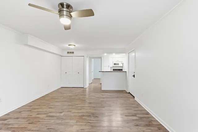 a view of empty room with wooden floor