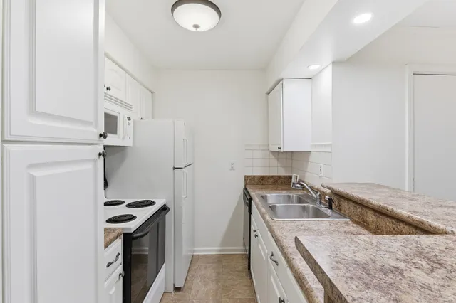 a kitchen that has a sink and a stove