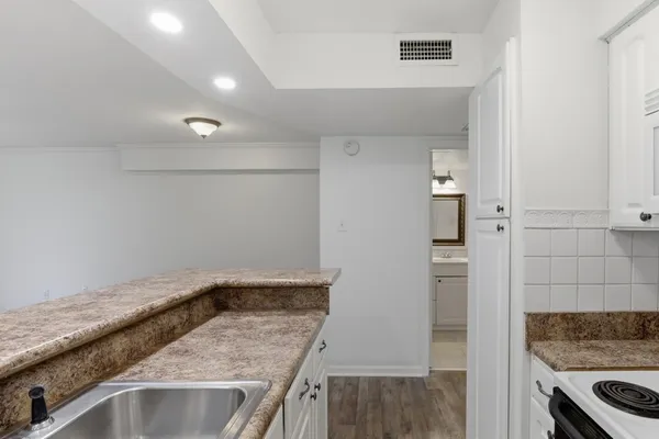 a view of a kitchen cabinets a sink and a stove top oven