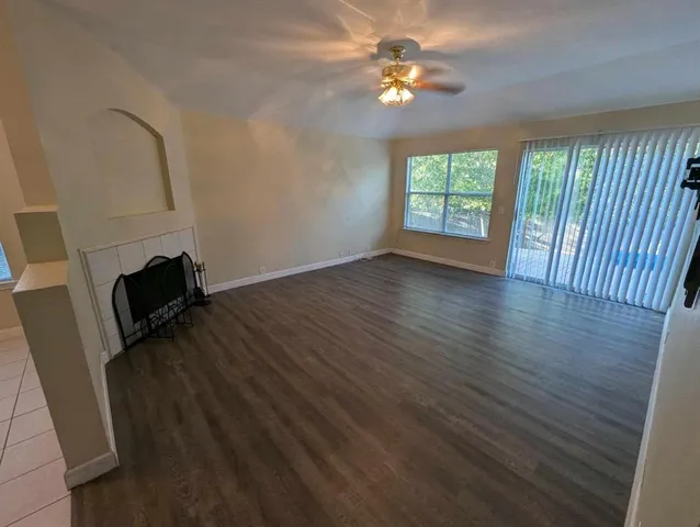 wooden floor in an empty room with a window