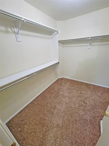 a bathroom with a granite countertop sink mirror vanity and shower