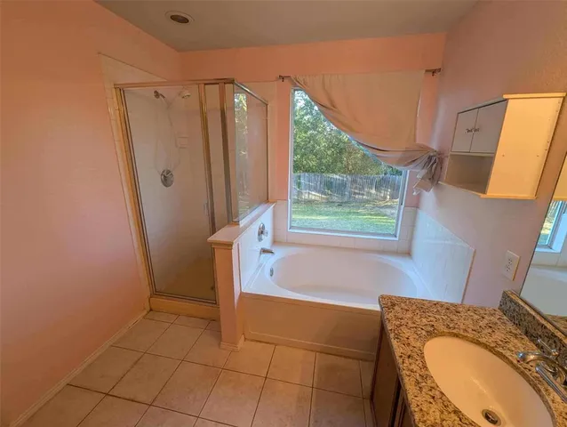 a bathroom with a granite countertop sink a mirror and shower
