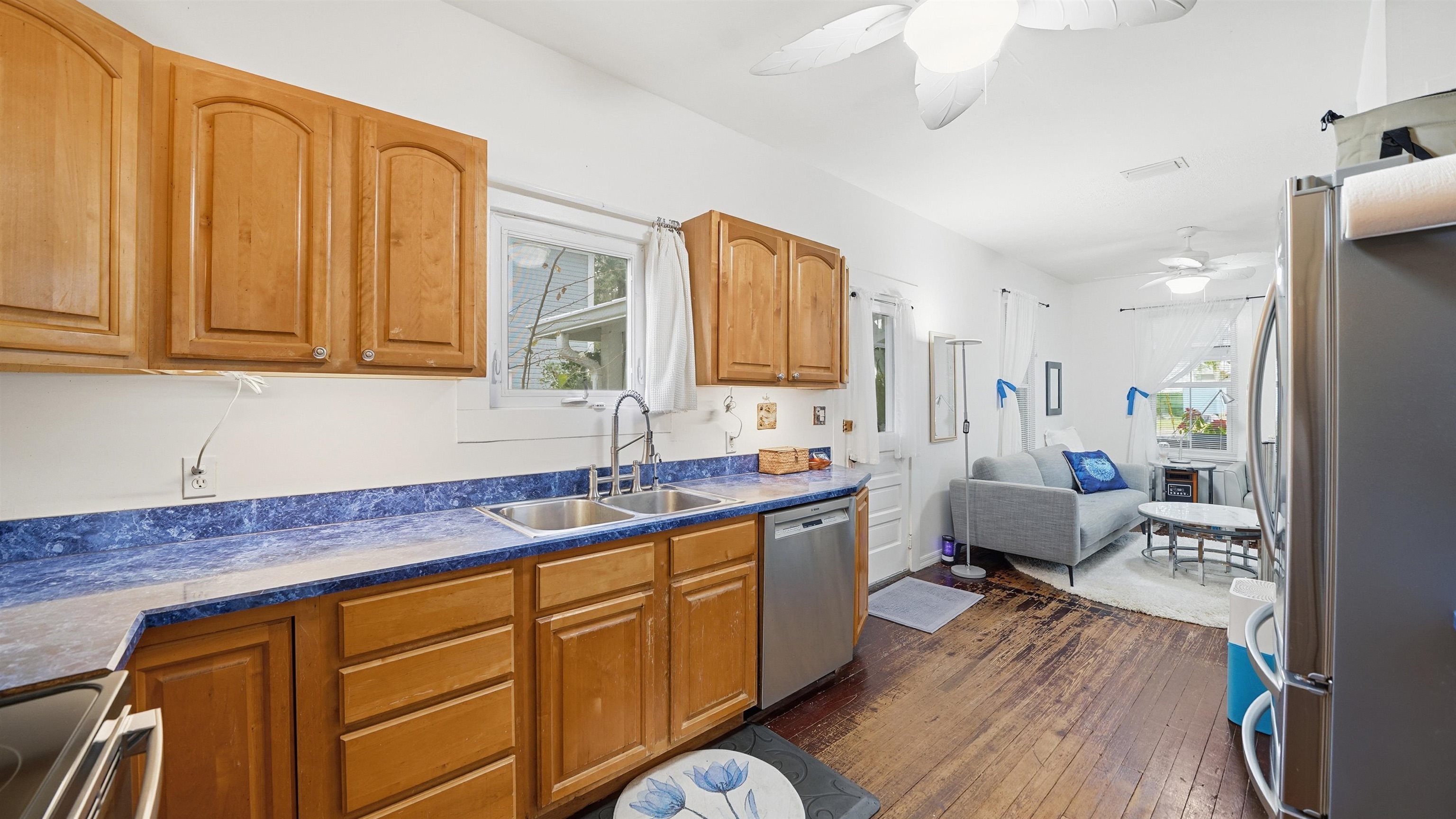 15 Davis Street St. Augustine, FL 32084 - Photo 15 of 48 a kitchen with stainless steel appliances granite countertop a sink dishwasher stove and wooden cabinets with wooden floor