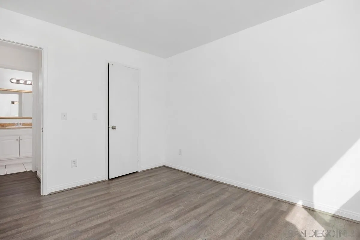3431 Capalina Road, Unit 16 San Marcos, CA 92069 - Photo 12 of 17 an empty room with wooden floor