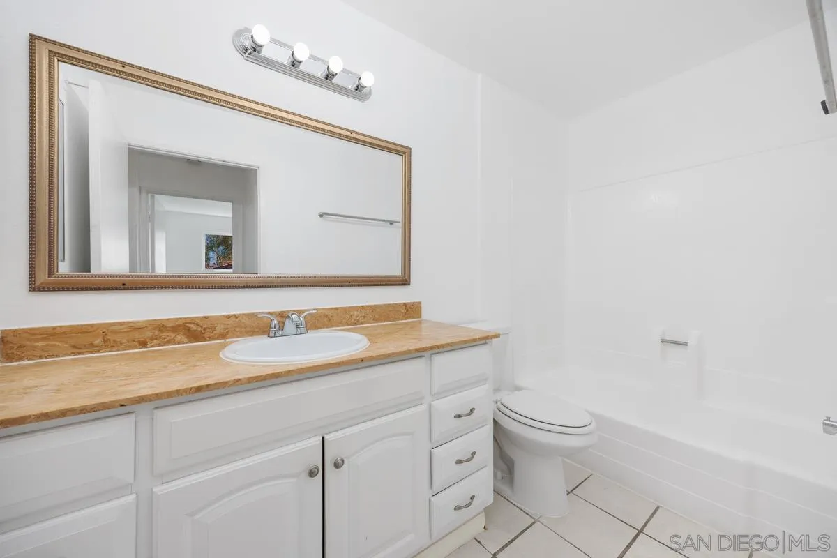 3431 Capalina Road, Unit 16 San Marcos, CA 92069 - Photo 14 of 17 a bathroom with a toilet sink and mirror