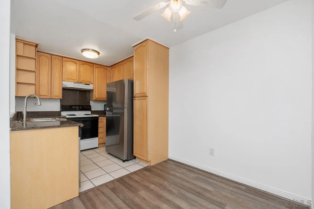 3431 Capalina Road, Unit 16 San Marcos, CA 92069 - Photo 8 of 17 a kitchen with a refrigerator sink and cabinets