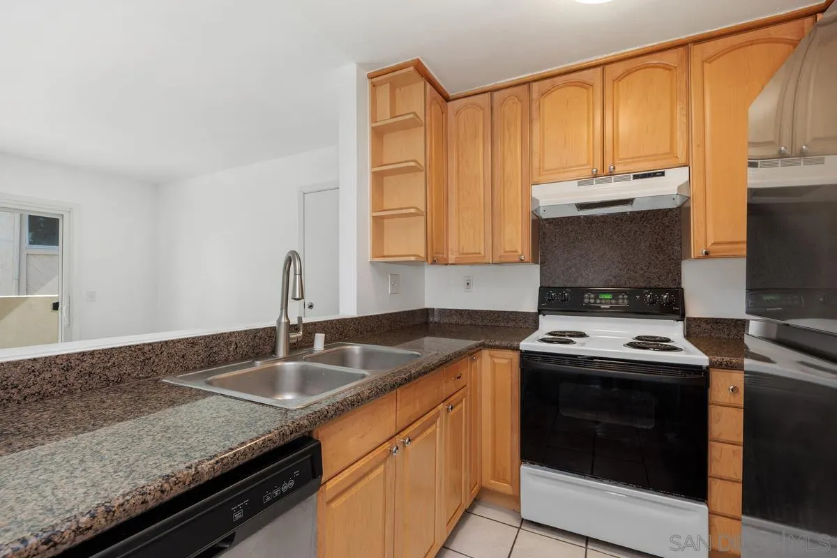 3431 Capalina Road, Unit 16 San Marcos, CA 92069 - Photo 9 of 17 a kitchen with a sink stove and cabinets
