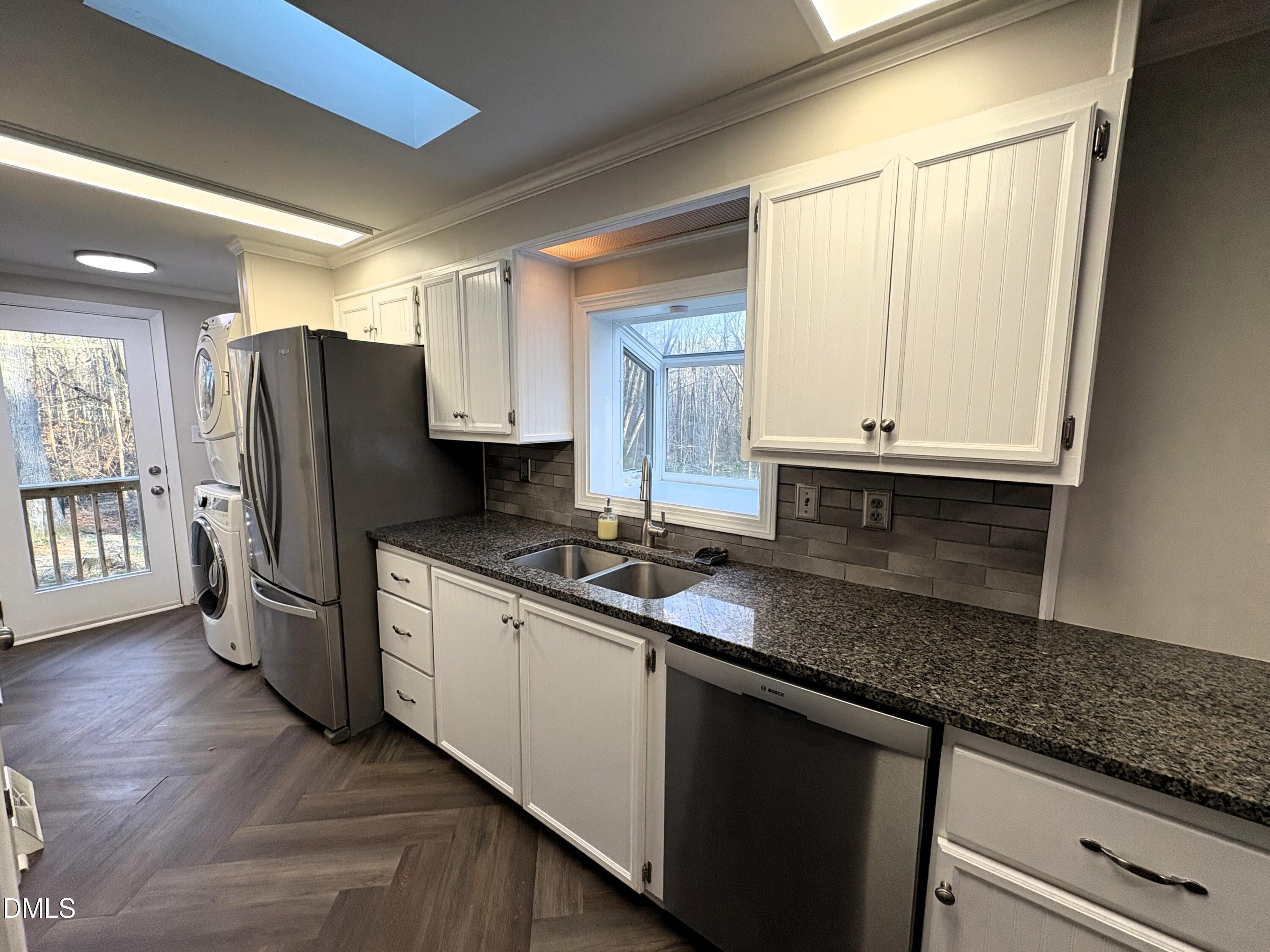 6100 Guess Road Rougemont, NC 27572 - Photo 19 of 35 a kitchen with stainless steel appliances granite countertop a refrigerator and a sink