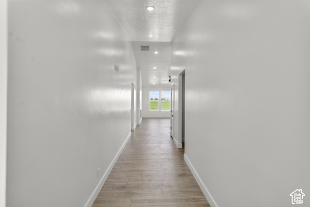 205 East 690th Street North Logan, UT 84321 - Photo 3 of 52 Recessed lighting, wood-finish flooring, white trim, and white walls