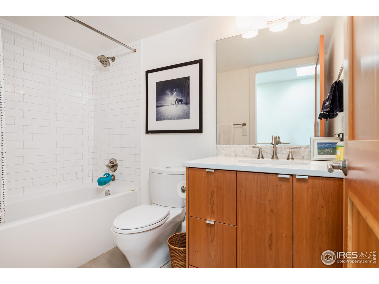 1229 Cedar Avenue Boulder, CO 80304 - Photo 18 of 29 a bathroom with a toilet a sink and mirror
