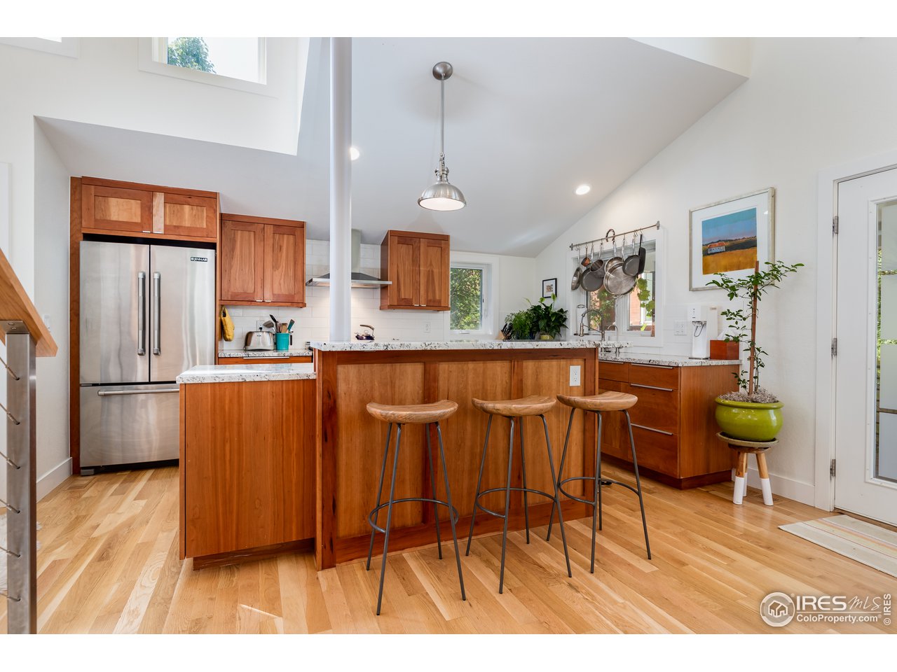 1229 Cedar Avenue Boulder, CO 80304 - Photo 3 of 29 a kitchen with stainless steel appliances kitchen island granite countertop a refrigerator a stove a sink dishwasher and white cabinets with wooden floor