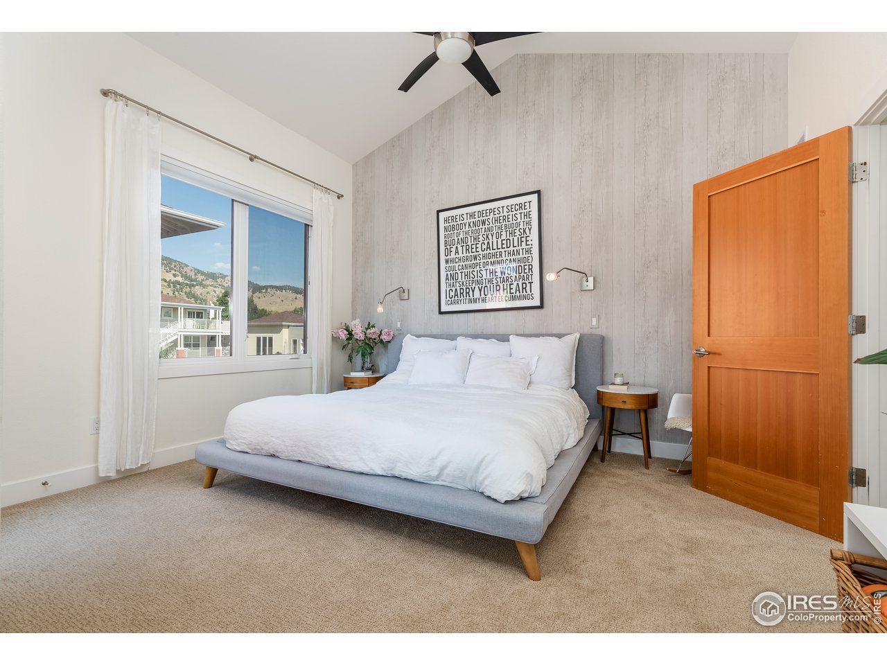 1229 Cedar Avenue Boulder, CO 80304 - Photo 9 of 29 a bedroom with a bed painting on wall and a window