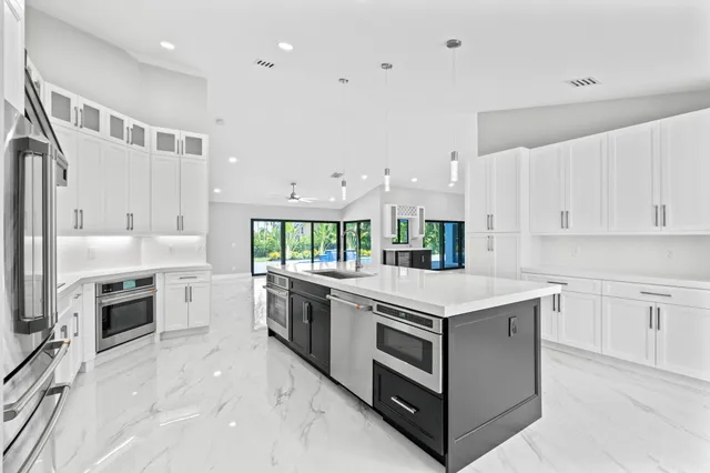 a kitchen with stainless steel appliances granite countertop a stove oven and a refrigerator