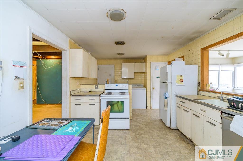 185 Carter Road Princeton, NJ 08540 - Photo 9 of 21 a kitchen with a refrigerator a stove top oven a sink and dishwasher with wooden floor