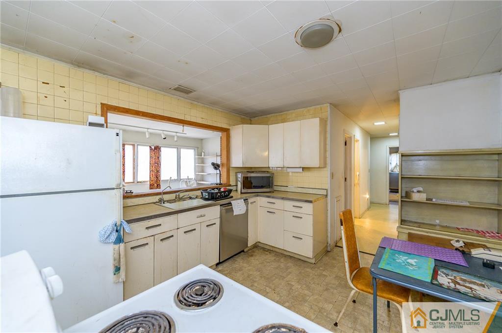 185 Carter Road Princeton, NJ 08540 - Photo 10 of 21 a kitchen with stainless steel appliances granite countertop a stove a sink and a refrigerator