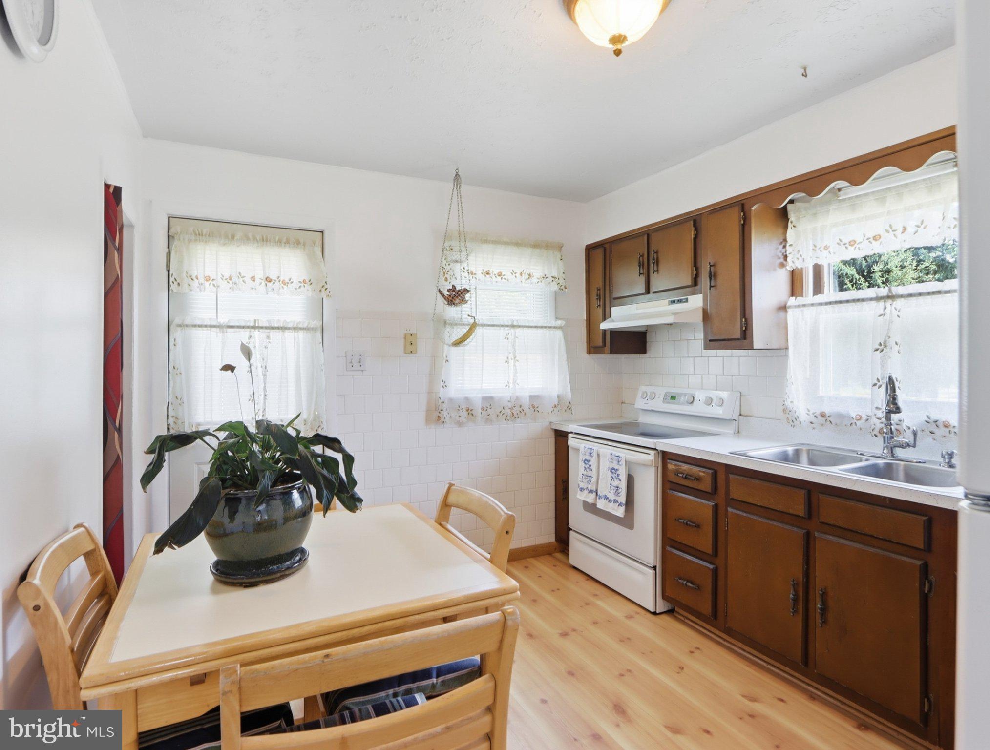 8176 Lea Road Pasadena, MD 21122 - Photo 7 of 23 Cozy kitchen with warm wooden accents.