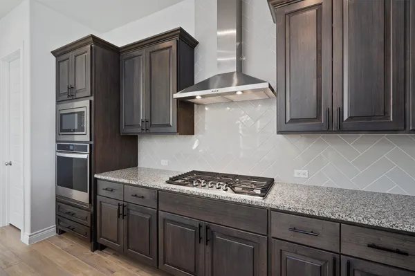 a large kitchen with stainless steel appliances sink a microwave and cabinets
