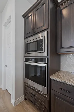 a kitchen with granite countertop a stove and a refrigerator