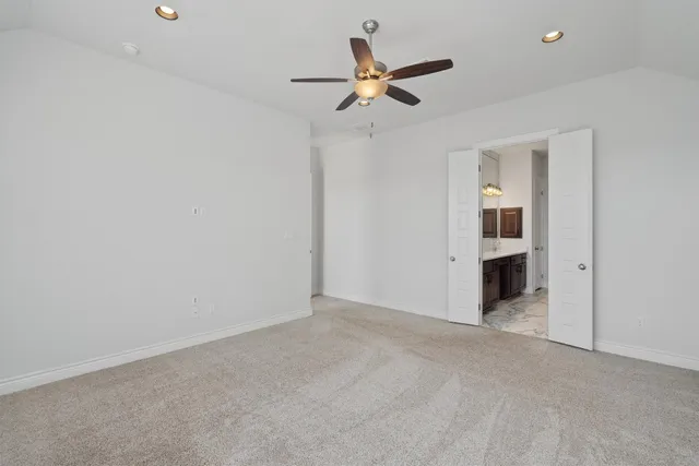 a kitchen with granite countertop kitchen island stainless steel appliances a sink stove and refrigerator