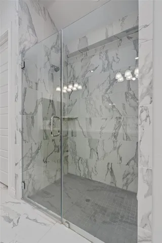 a bathroom with a double vanity sink mirror and shower