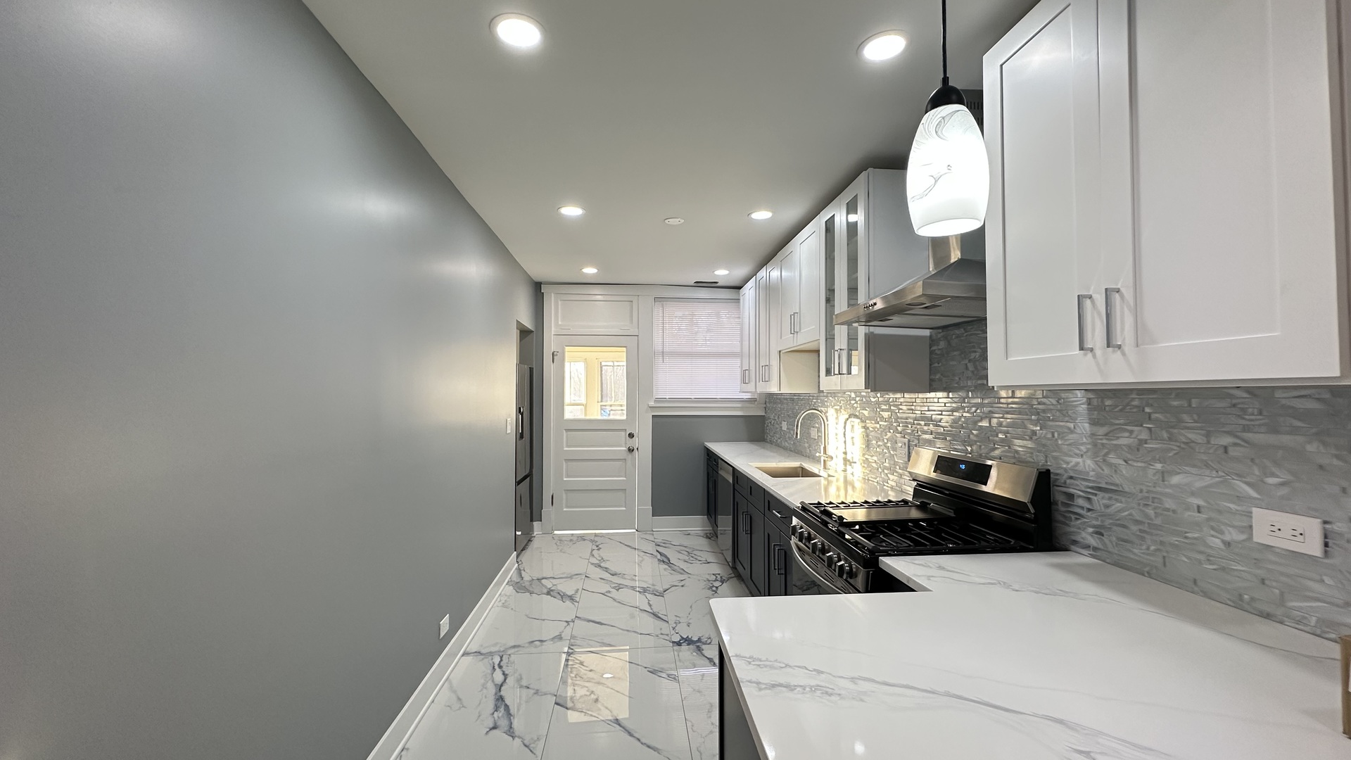 5224 North Bernard Street, Unit 1 Chicago, IL 60625 - Photo 11 of 13 a kitchen with a sink and chairs