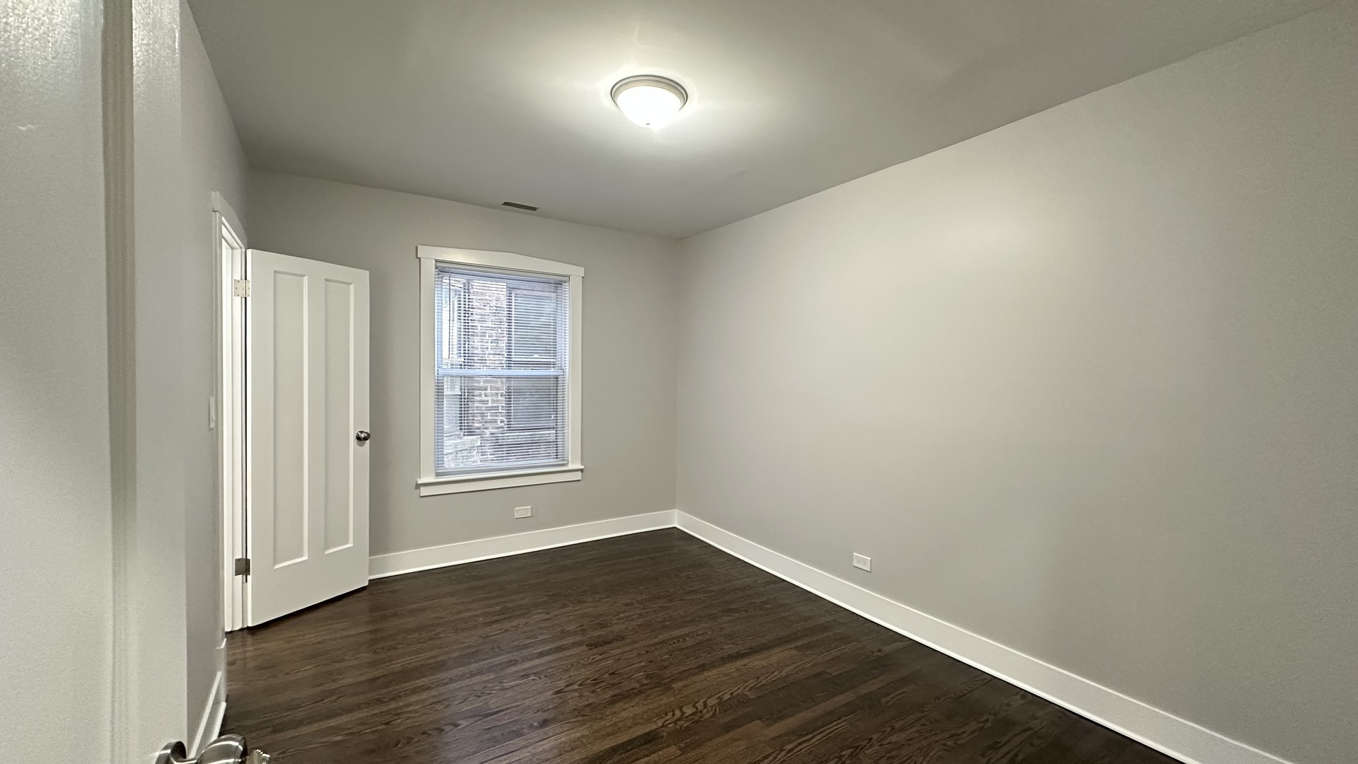 5224 North Bernard Street, Unit 1 Chicago, IL 60625 - Photo 4 of 13 an empty room with wooden floor and windows
