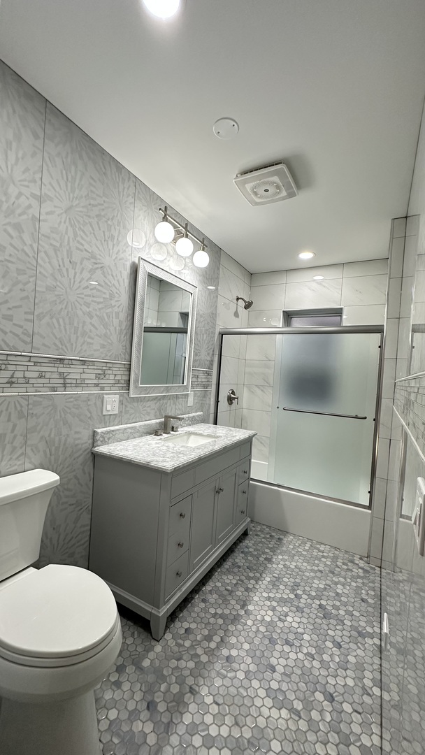 5224 North Bernard Street, Unit 1 Chicago, IL 60625 - Photo 8 of 13 a bathroom with a toilet sink and mirror