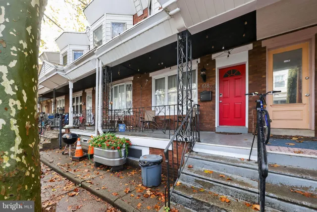 a front view of a house with outdoor seating