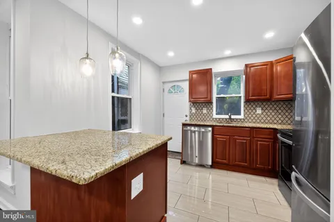 a kitchen with stainless steel appliances granite countertop a sink and stove