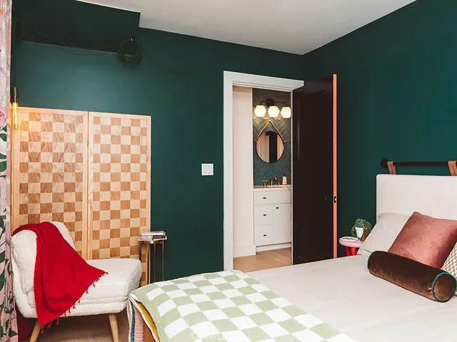 a bedroom with a bed and chair