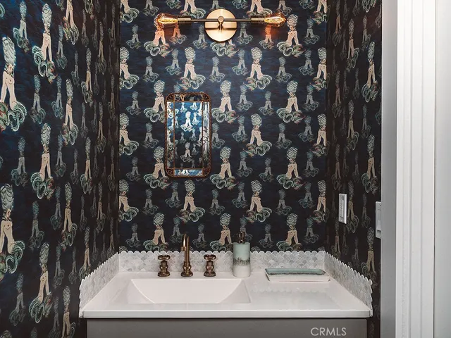 a bathroom with a sink and mirror