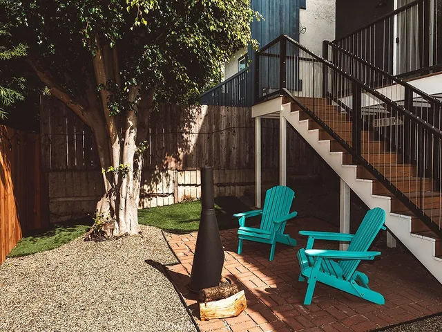 a view of a chairs and table in the backyard