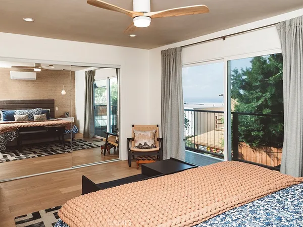 a bedroom with a large bed and a large window