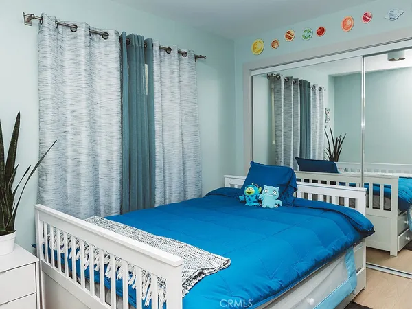 a bedroom with a bed and a large dresser